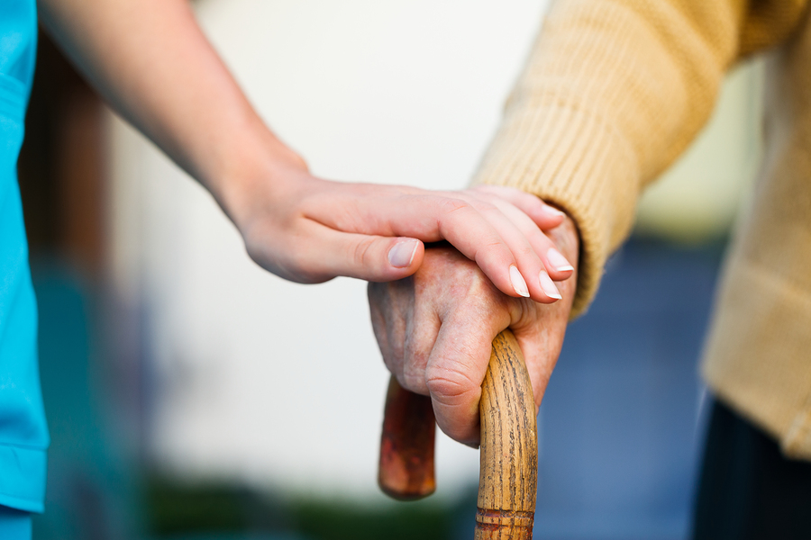 Holding senior patient's hand